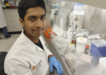 Arhan Rao sits in front of his workstation in the lab.