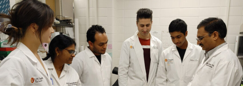 Dr. Vadlamudi shows students something out of frame.