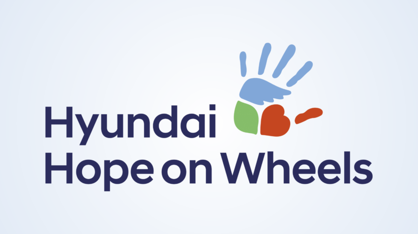 Logo of "Hyundai Hope on Wheels" featuring a blue handprint, green square, and red heart on a light blue background. Transcribed Text: Hyundai Hope on Wheels