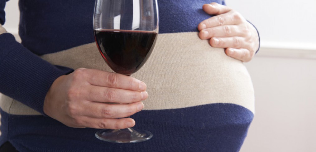 Pregnant woman drinking wine