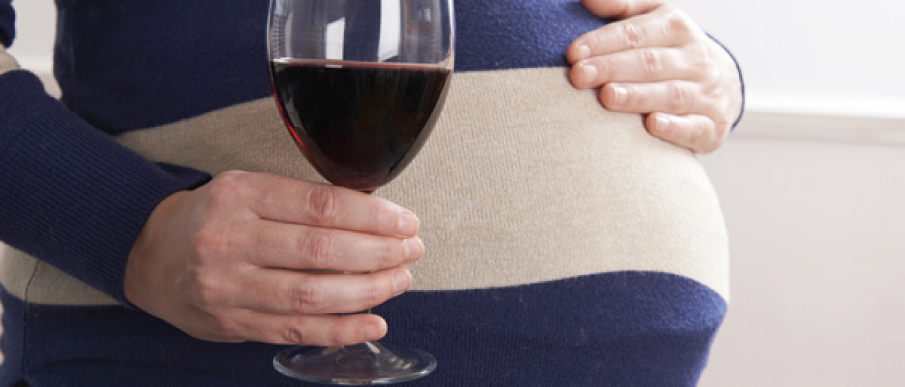 Pregnant woman drinking wine