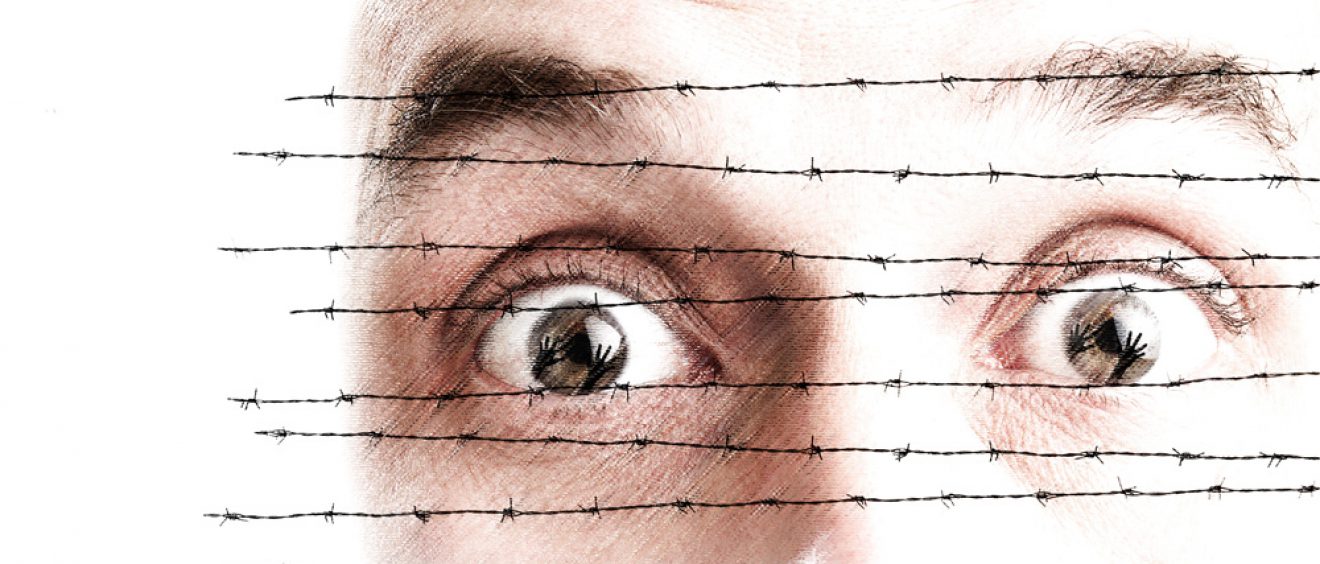 face behind barbed wire