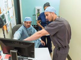 Vidal Balderas, D.D.S., M.P.H., consults with Mohamed Fouad Imam, D.D.S., at San Antonio Christian Dental Clinic.