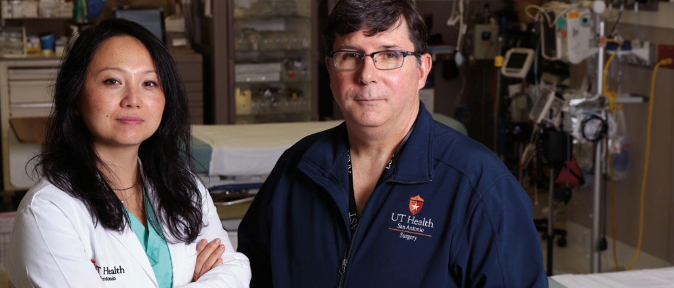 Trauma surgeons Lillian Liao, M.D., M.P.H. ’04, and Ronald Stewart, M.D. ’85, in an operating room