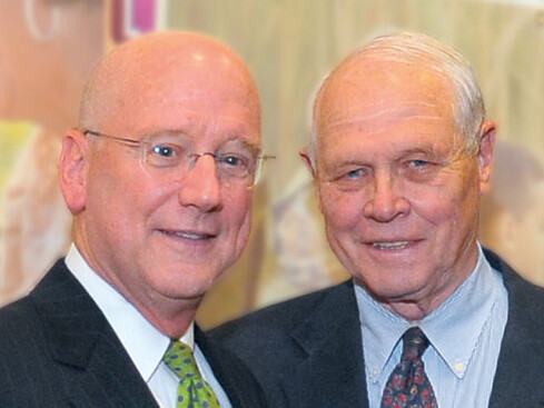 Glenn Biggs, (right), first chairman of the Health Science Center Development Board, celebrates the NCI-CTRC designation with President Henrich.