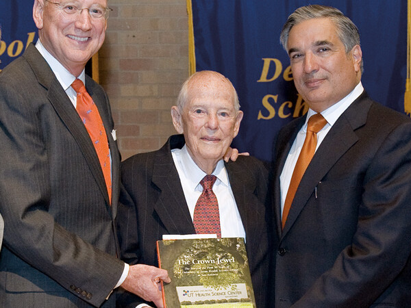 (L-R) William L. Henrich, M.D., MACP, Health Science Center president, Frank Harrison, M.D., Ph.D., and Francisco G. Cigarroa, M.D., chancellor of The University of Texas System, proudly hold a copy of “The Crown Jewel.”