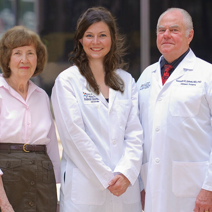 Kenneth Sirinek, M.D., Ph.D., (right) and Connie Aust, (left) wife of the late J. Bradley Aust, M.D., Ph.D., congratulate Katie Wiggins-Dolvik, M.D. the first recipient of the Dr. Ken and Peg Sirinek Endowed Scholarship in General Surgery at the UT Health Science Center.