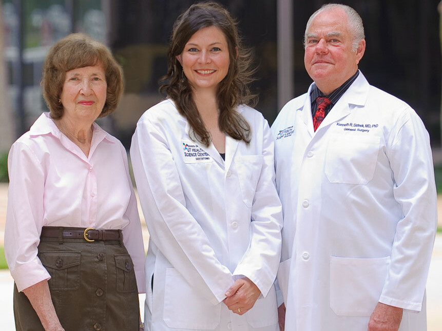Kenneth Sirinek, M.D., Ph.D., (right) and Connie Aust, (left) wife of the late J. Bradley Aust, M.D., Ph.D., congratulate Katie Wiggins-Dolvik, M.D. the first recipient of the Dr. Ken and Peg Sirinek Endowed Scholarship in General Surgery at the UT Health Science Center.