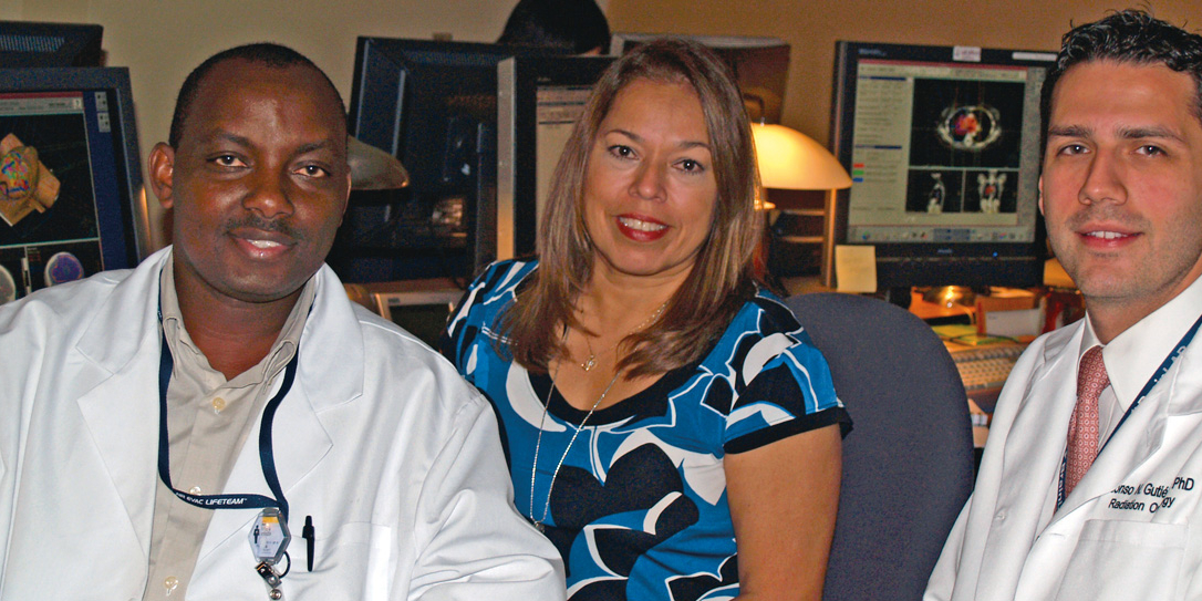 Titus Kyenzeh (left) is a student in the Department of Radiation Oncology’s medical dosimetry certification program, which just earned accreditation thanks to a yearlong effort by Clinical Director Diana Baacke (center), Education Director Alonso Gutiérrez, Ph.D., (right) and the program’s director, Nikos Papanikolaou, Ph.D., (not pictured).