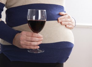 Pregnant woman drinking wine