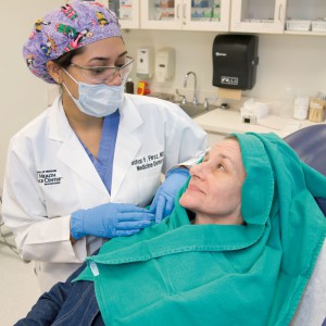 Dr. Firoz discusses skin cancer prevention with her patient as she prepares her for Mohs surgery.