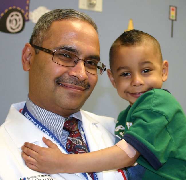 Dr. Naveen Mittal gets a hug from 4-year-old Kamryn Lucio of Lubbock who underwent a liver transplant operation at CHRISTUS Santa Rosa Children’s Hospital in spring 2010.