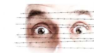 face behind barbed wire