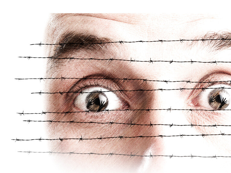 face behind barbed wire