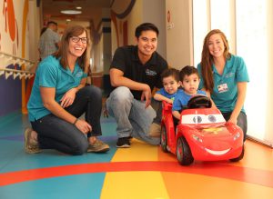 OT students help twins John and Jacob use a modified car