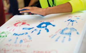 child with cancer places handprint