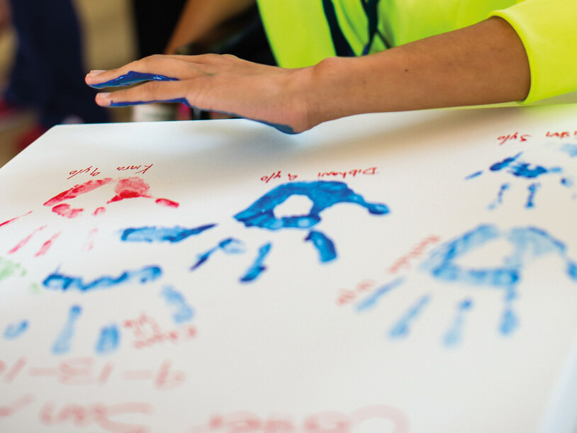 child with cancer places handprint