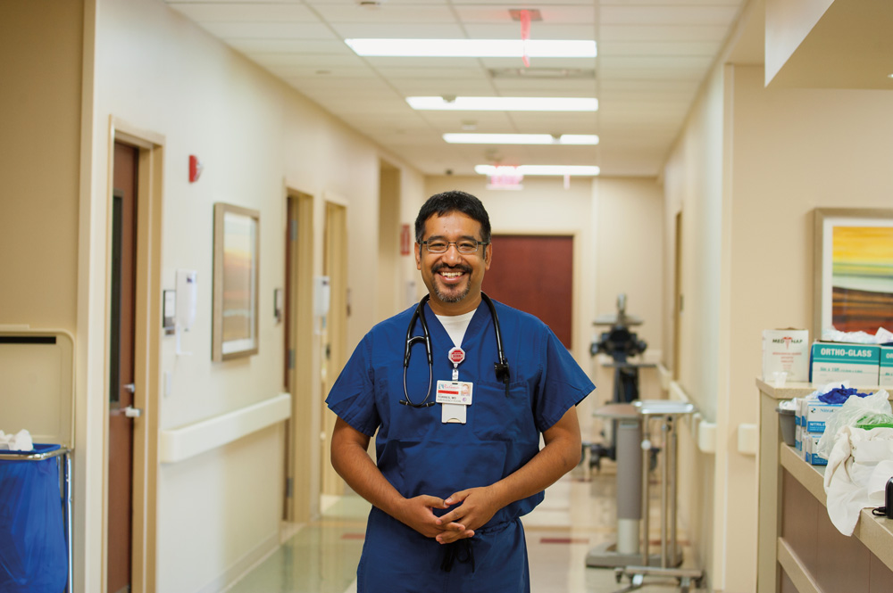 Joel Torres, M.D., stands in an emergency room hallway