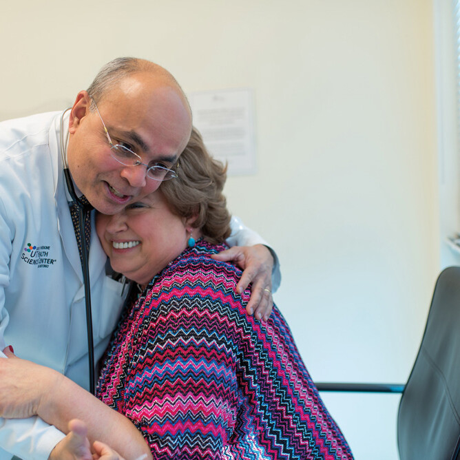 Anand Karnad, M.D. hugging patient