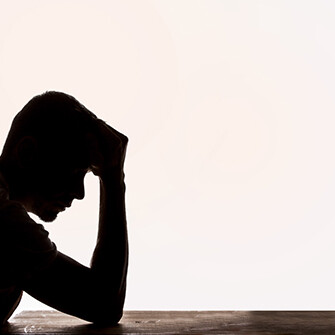 Silhouette of a man struggling with mental illness.