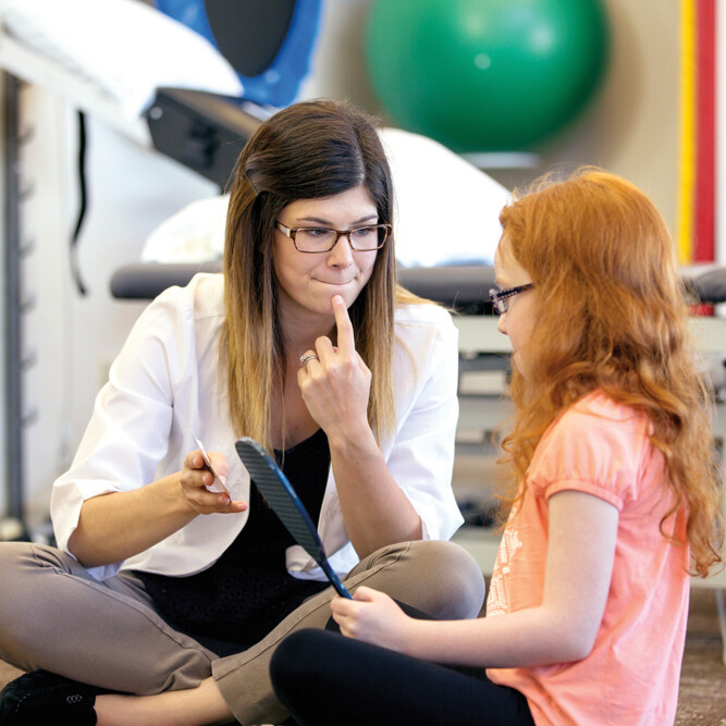 Speech-language pathologist working with a young patient.
