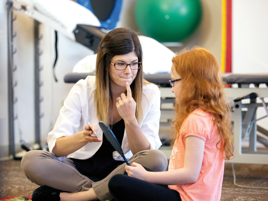 Speech-language pathologist working with a young patient.