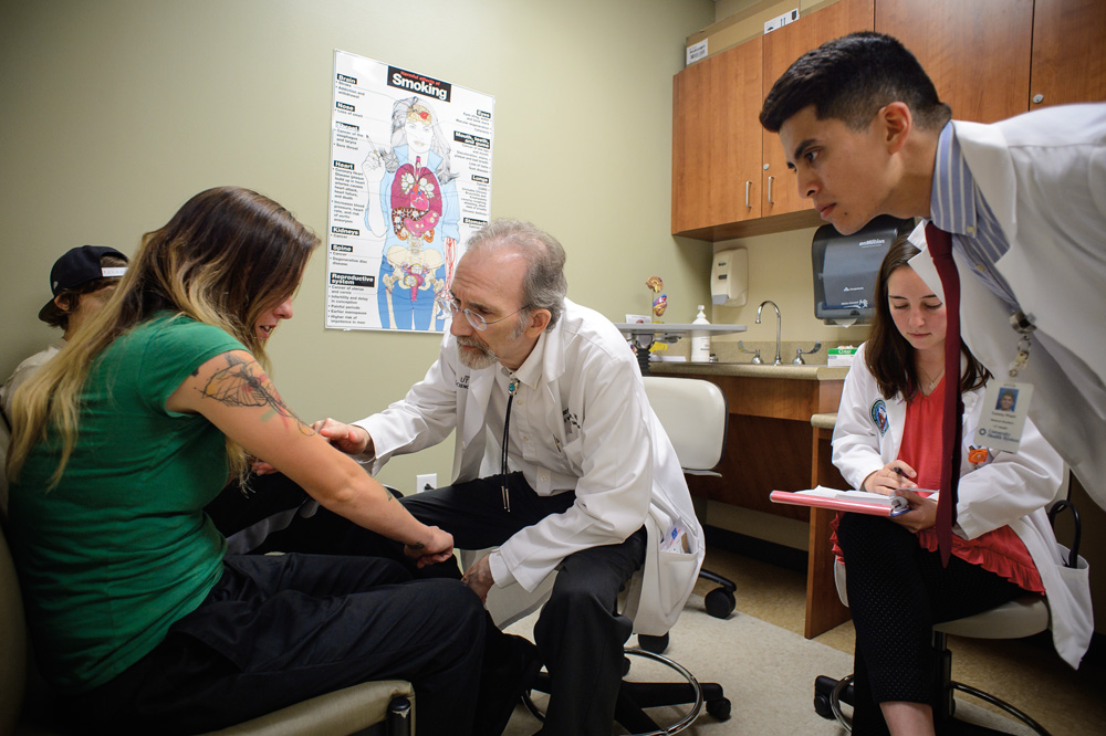 doctor and medical students examine a patient