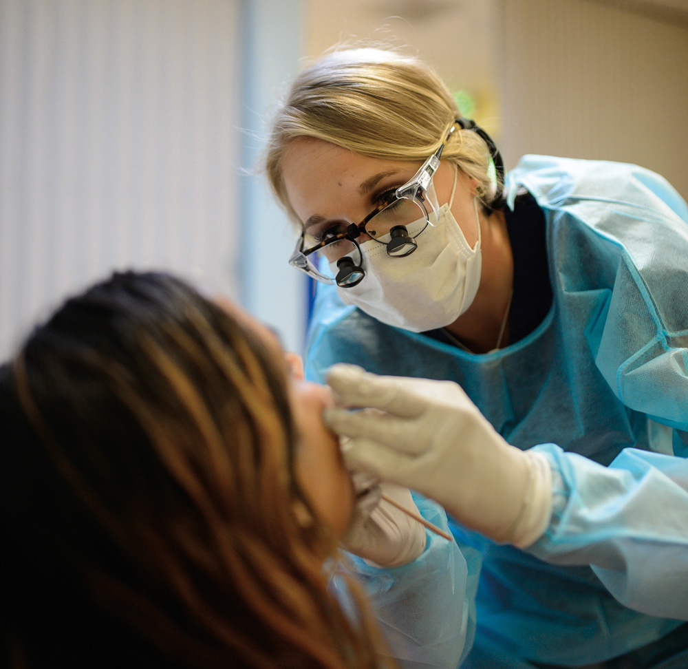 dental student examines patient