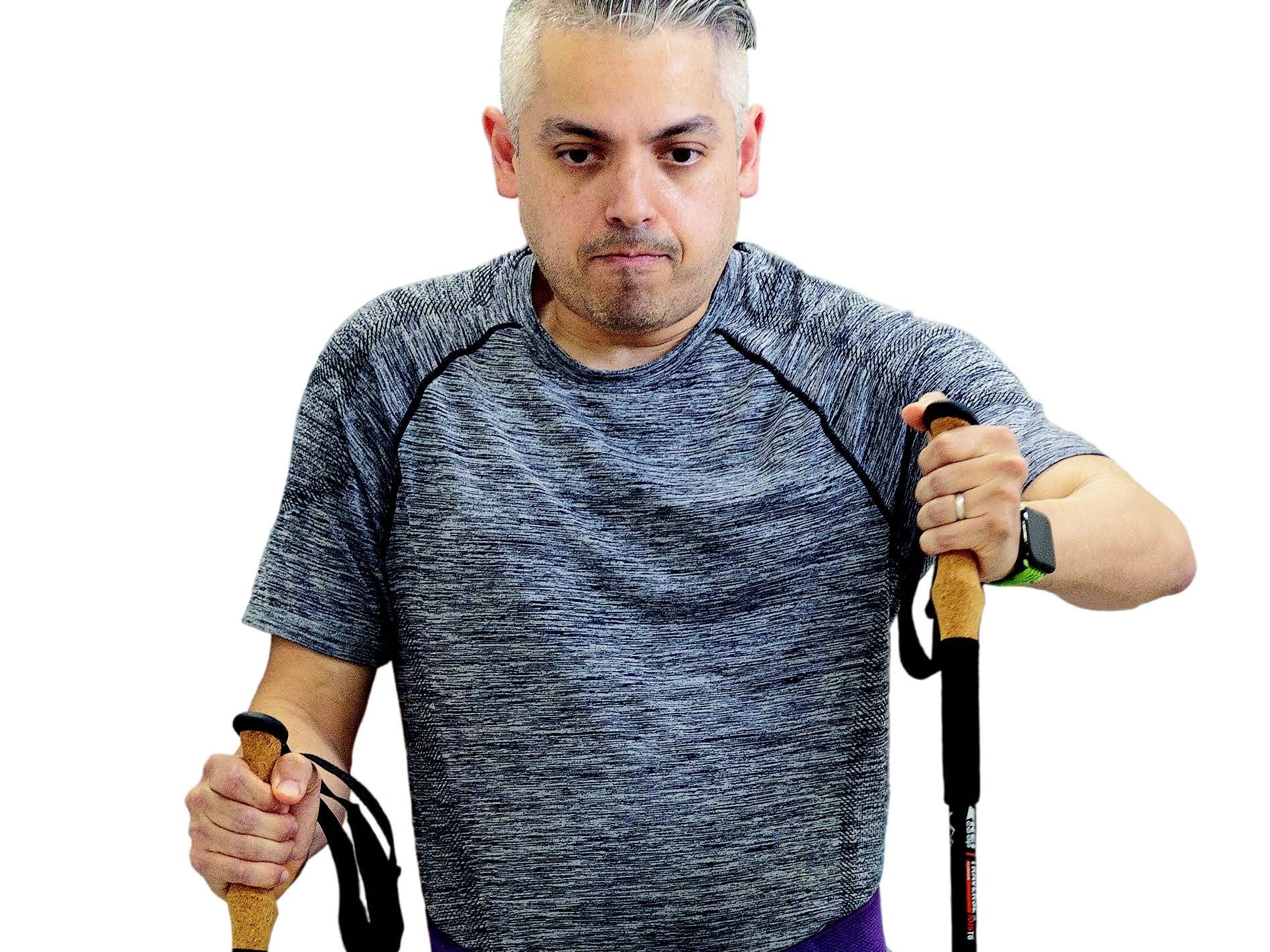 A patient walks with the aid of walking sticks