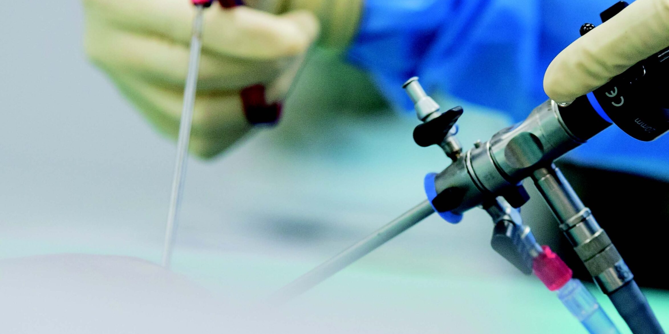 image of hands guiding robotic surgery tools