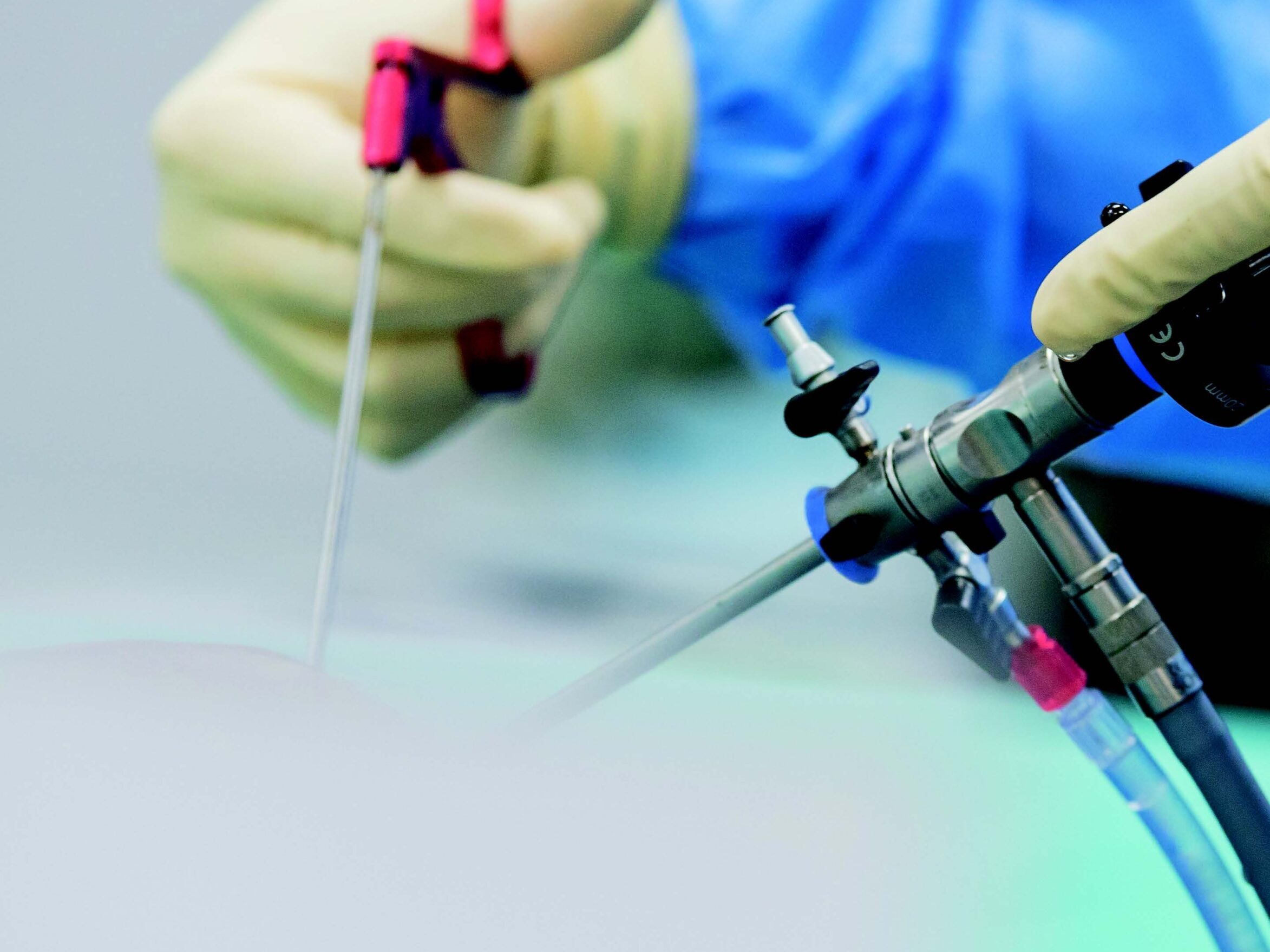 image of hands guiding robotic surgery tools