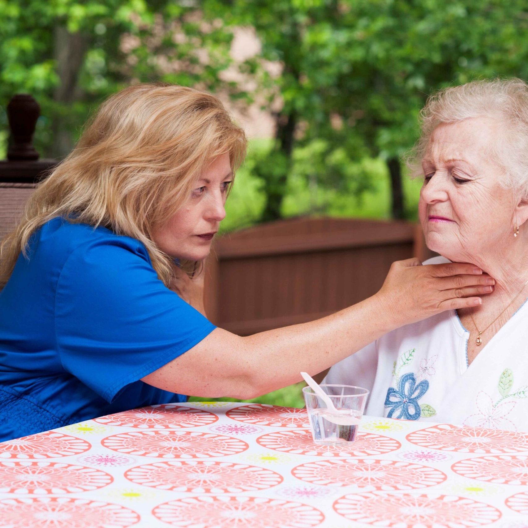 Photo of health provider assisting patient experiencing trouble swallowing