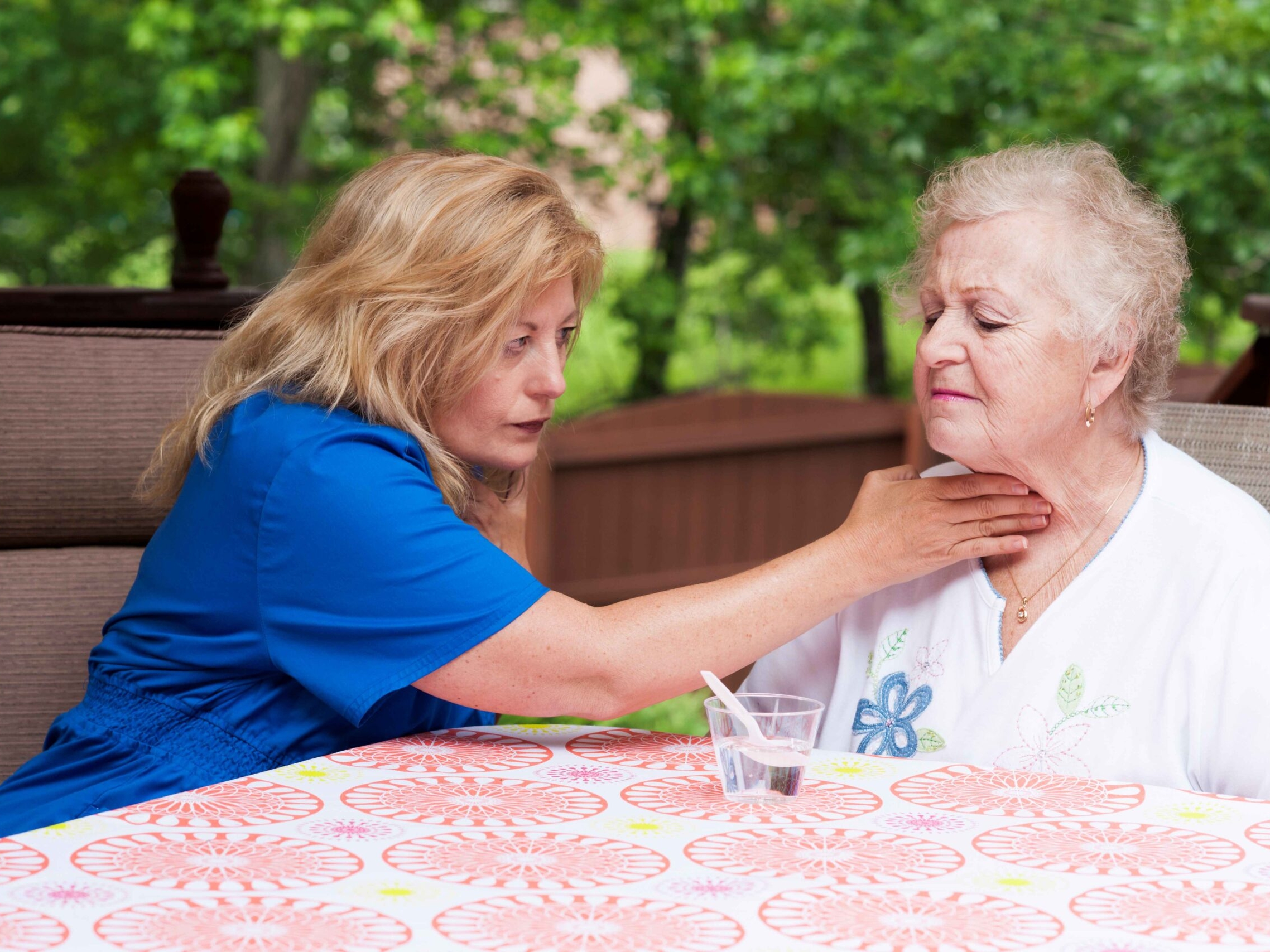 Photo of health provider assisting patient experiencing trouble swallowing