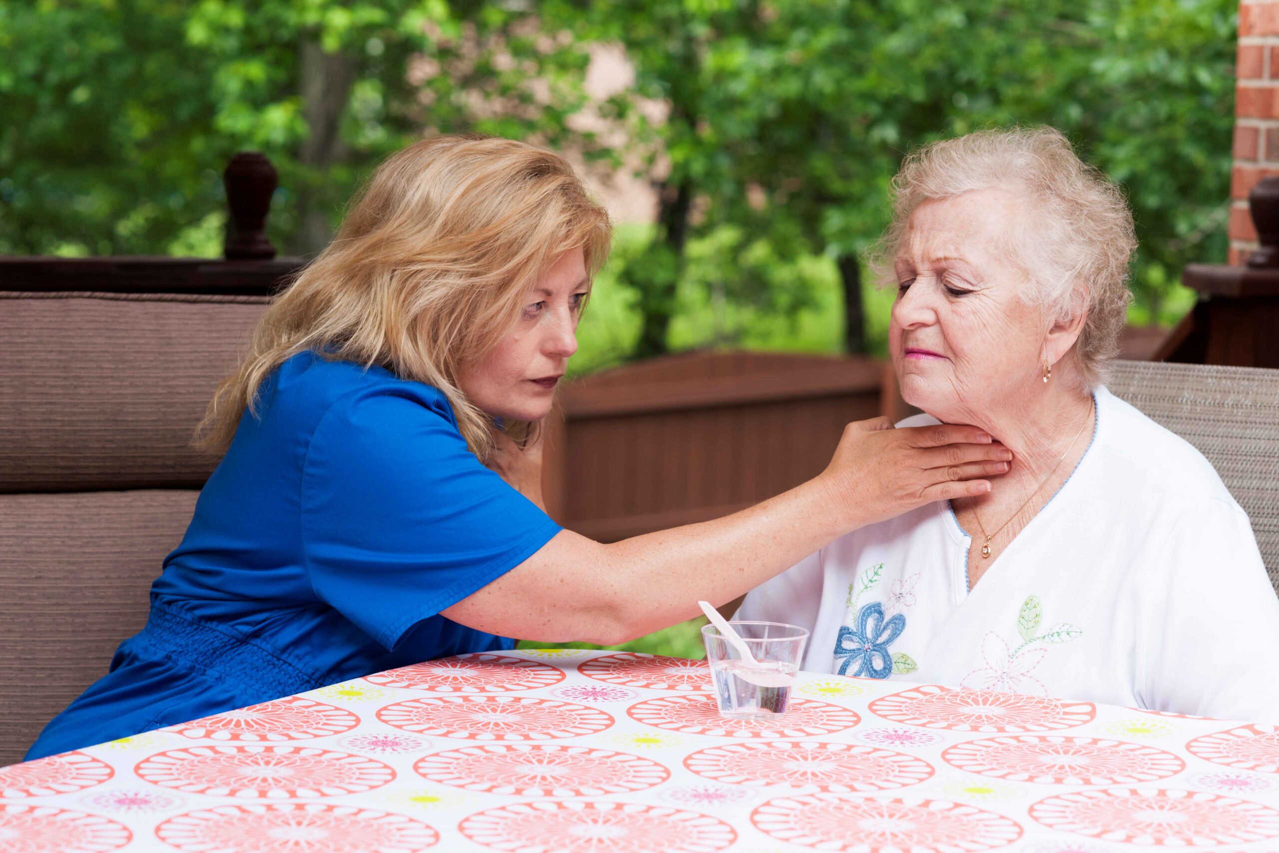 Photo of health provider assisting patient experiencing trouble swallowing