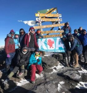 Kelley Hitchman at the summit of Mount Kilimanjaro