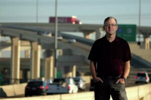 Brian Purcell standing in front of highway
