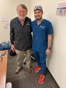 Dr. Taylor and Javy Garza hug each other's side and smile.