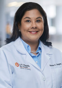 Professional headshot of Dr. Delgado in her clinical white coat.