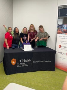 Five female caregivers stand together.