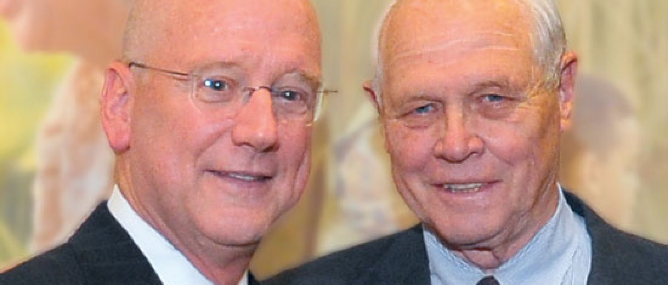 Glenn Biggs, (right), first chairman of the Health Science Center Development Board, celebrates the NCI-CTRC designation with President Henrich.