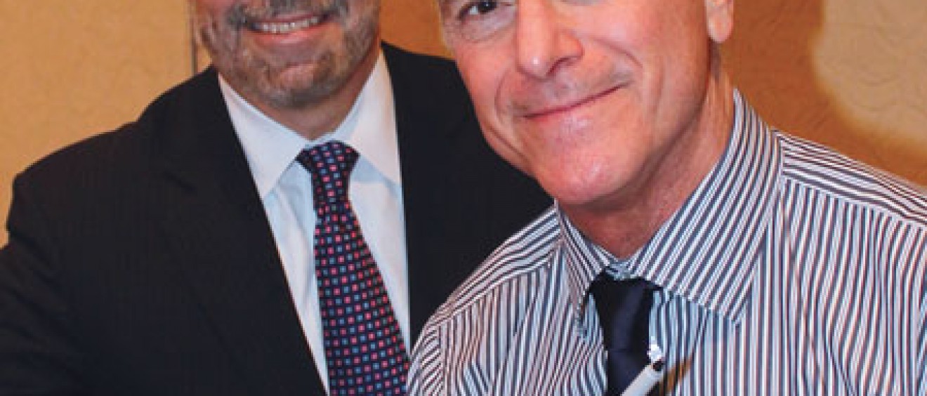 Author A. Scott Berg (right) signs his book "Wilson," for Francisco González-Scarano, M.D., dean of the School of Medicine.