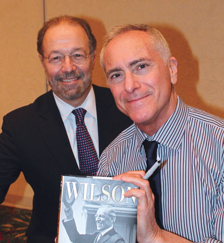 Author A. Scott Berg (right) signs his book "Wilson," for Francisco González-Scarano, M.D., dean of the School of Medicine.