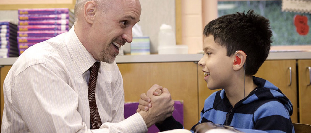 Blane Trautwein, Ed.D, (pictured with a student) works with students at Sunshine Cottage School for Deaf Children