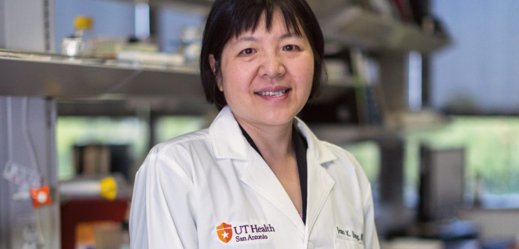Jean Jiang, Ph.D., stands in a lab.