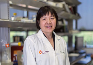 Jean Jiang, Ph.D., stands in a lab.
