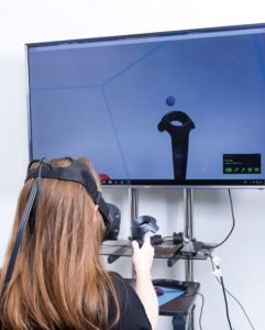 student sits at a virtual reality station