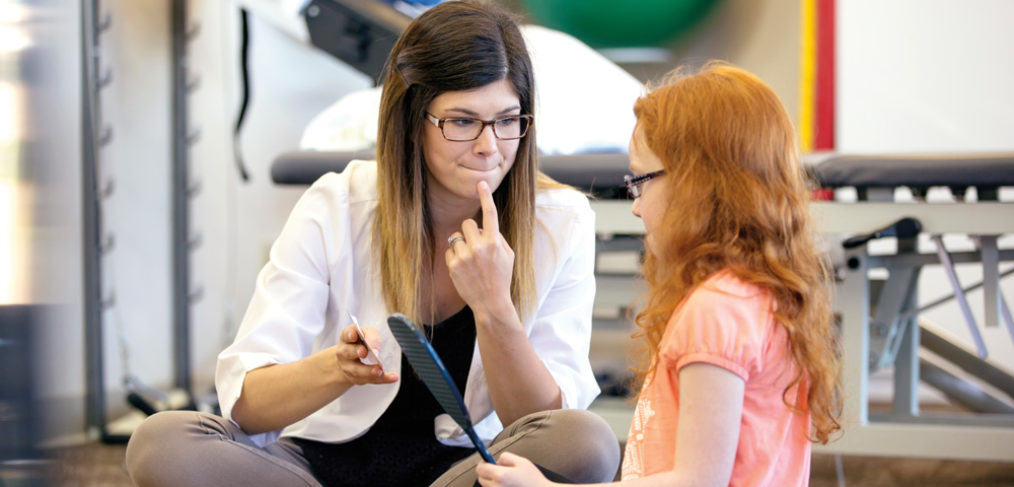 Speech-language pathologist working with a young patient.
