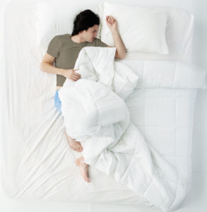 man asleep in bed