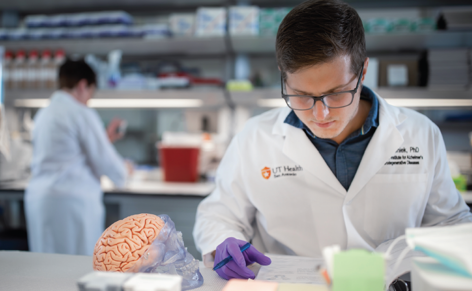 Bieniek reviews paperwork in a lab.