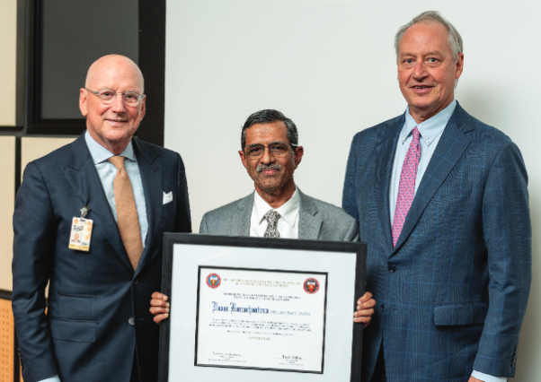Vasan Ramachandran, MD, stands between William L. Henrich, MD, MACP, president of UT Health San Antonio, and Taylor Eighmy, PhD, president of UTSA.